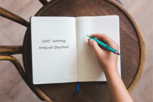 An LSAT student’s study desk with an open 'LSAT Wrong Answer Journal