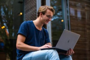 Student smiling while looking for LSAT test dates.