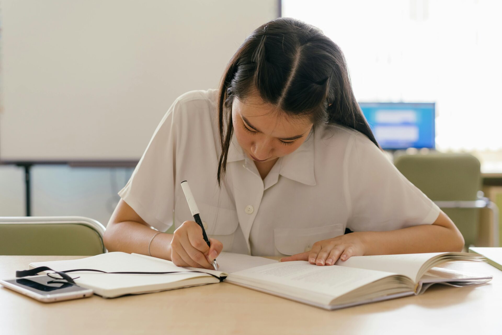 Student actively journaling during LSAT prep, reflecting on mistakes and refining strategies to improve LSAT performance.